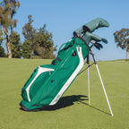 Green golf bag with clubs on a grassy field