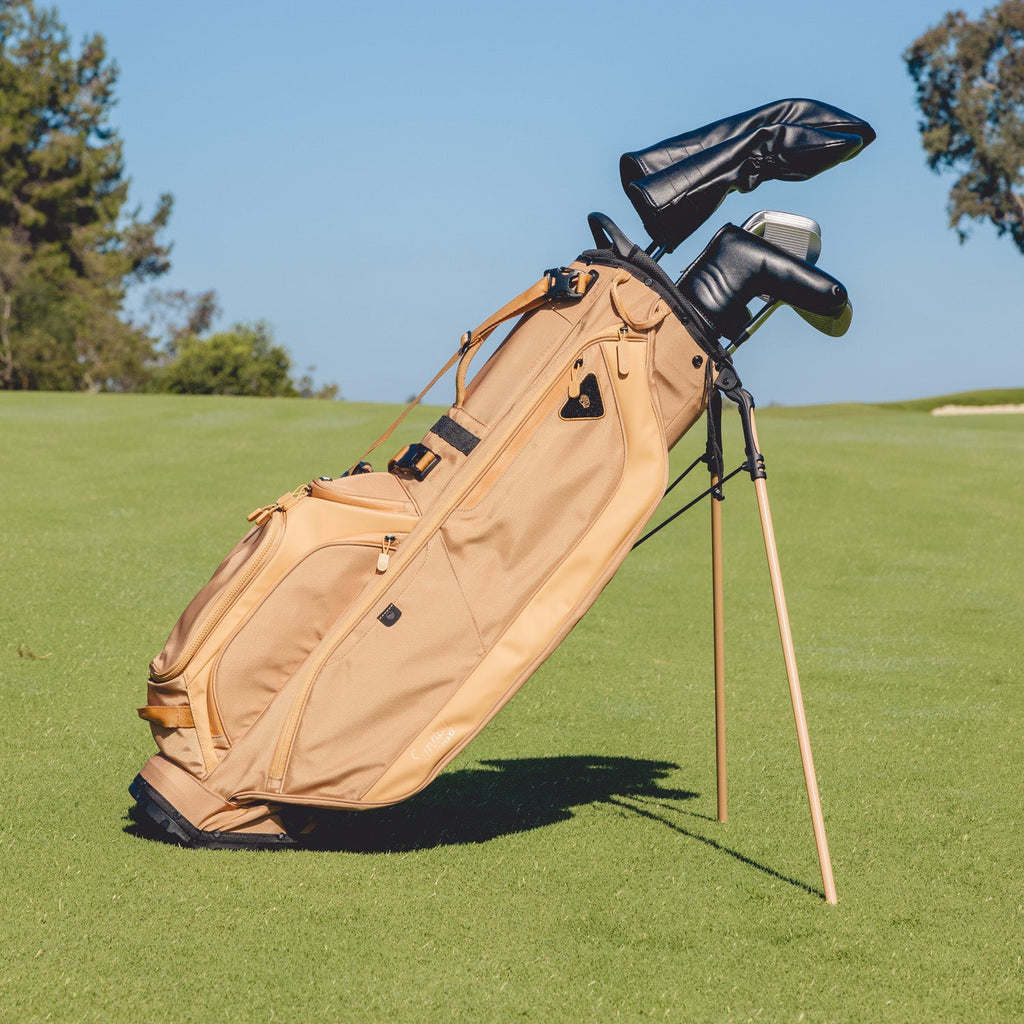 Golf bag with clubs on a grassy field