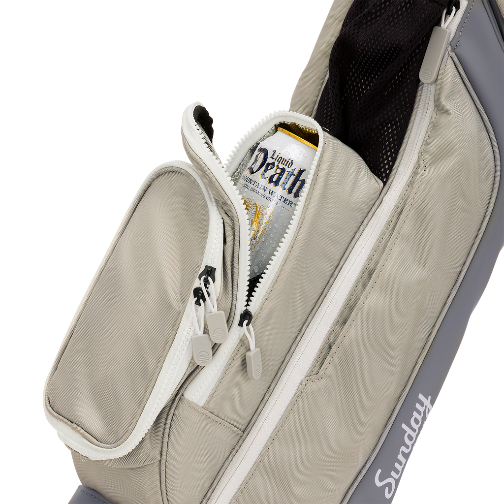 A close up shot of Cool Gray Loma golf bag's insulated pocket with a canned drink inside
