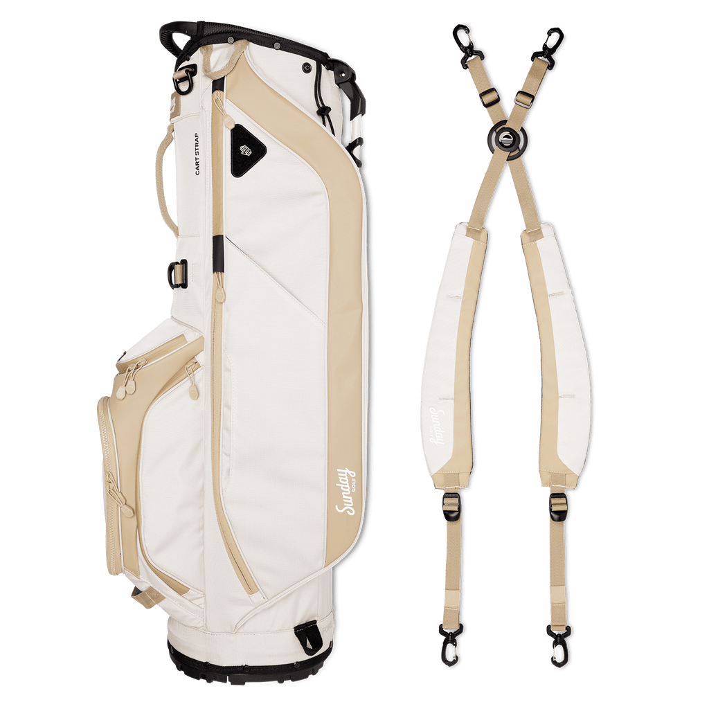 A full shot of Ryder golf bag in toasted almond laying flat sideways beside its double strap