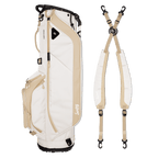 A full shot of Ryder golf bag in toasted almond laying flat sideways beside its double strap