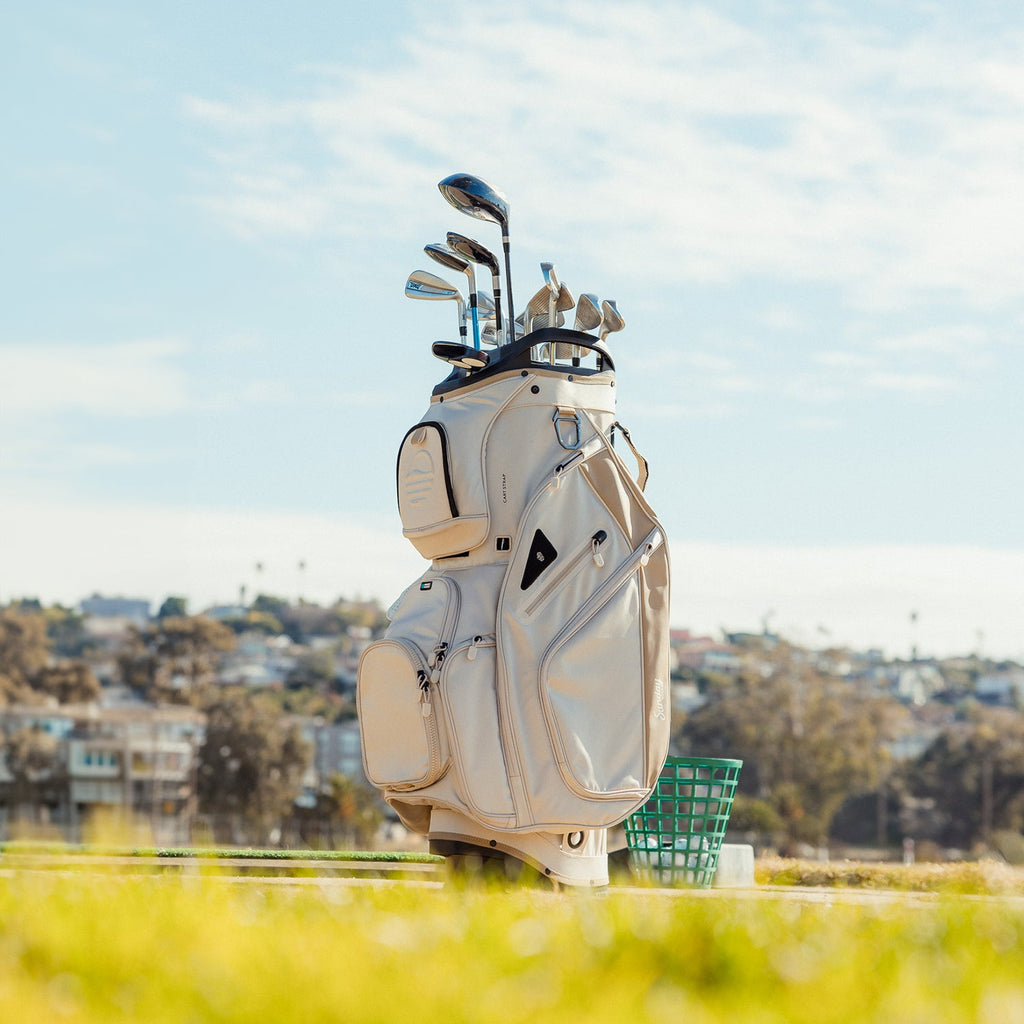 Front shot of Big Rig golf bag in toasted almond on the course showing the pockets and some of its features