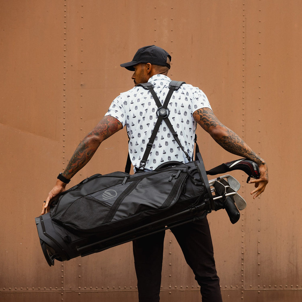 A man carrying The Ranger golf bag on  his back